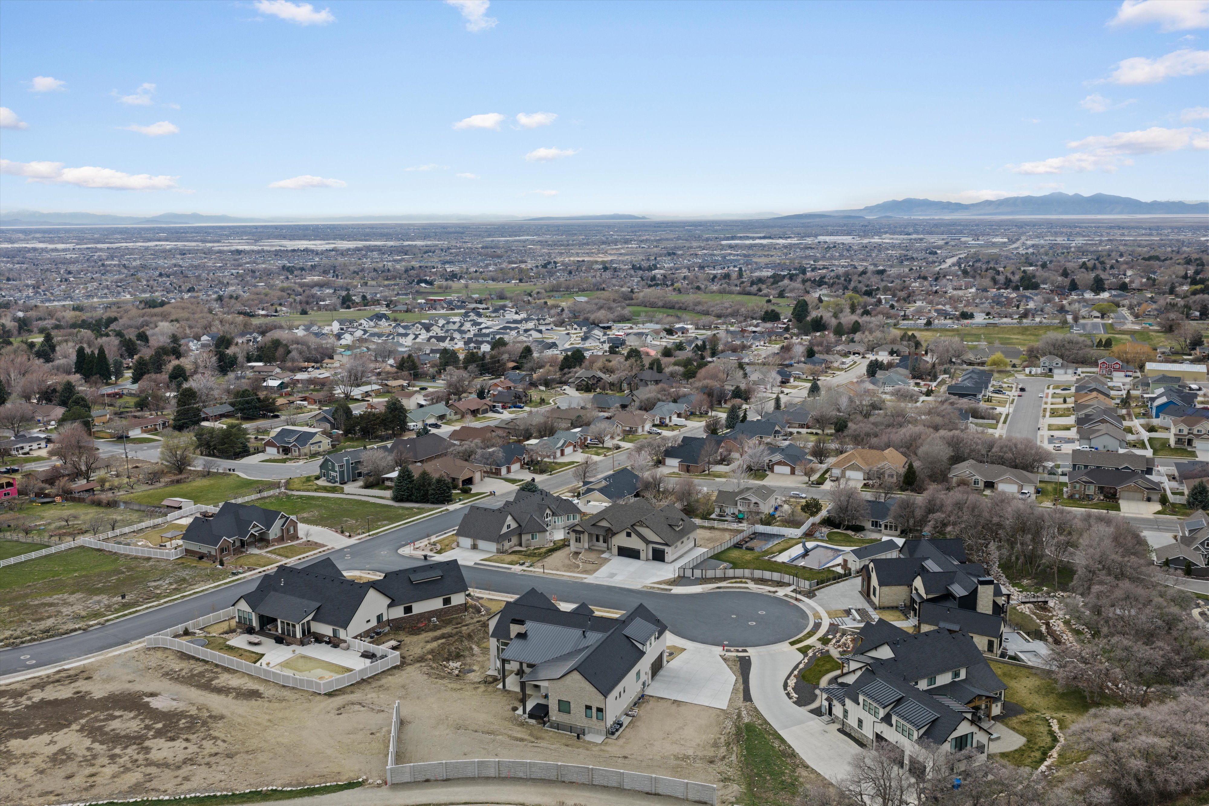 Aerial perspective of suburban area with a mountainous background