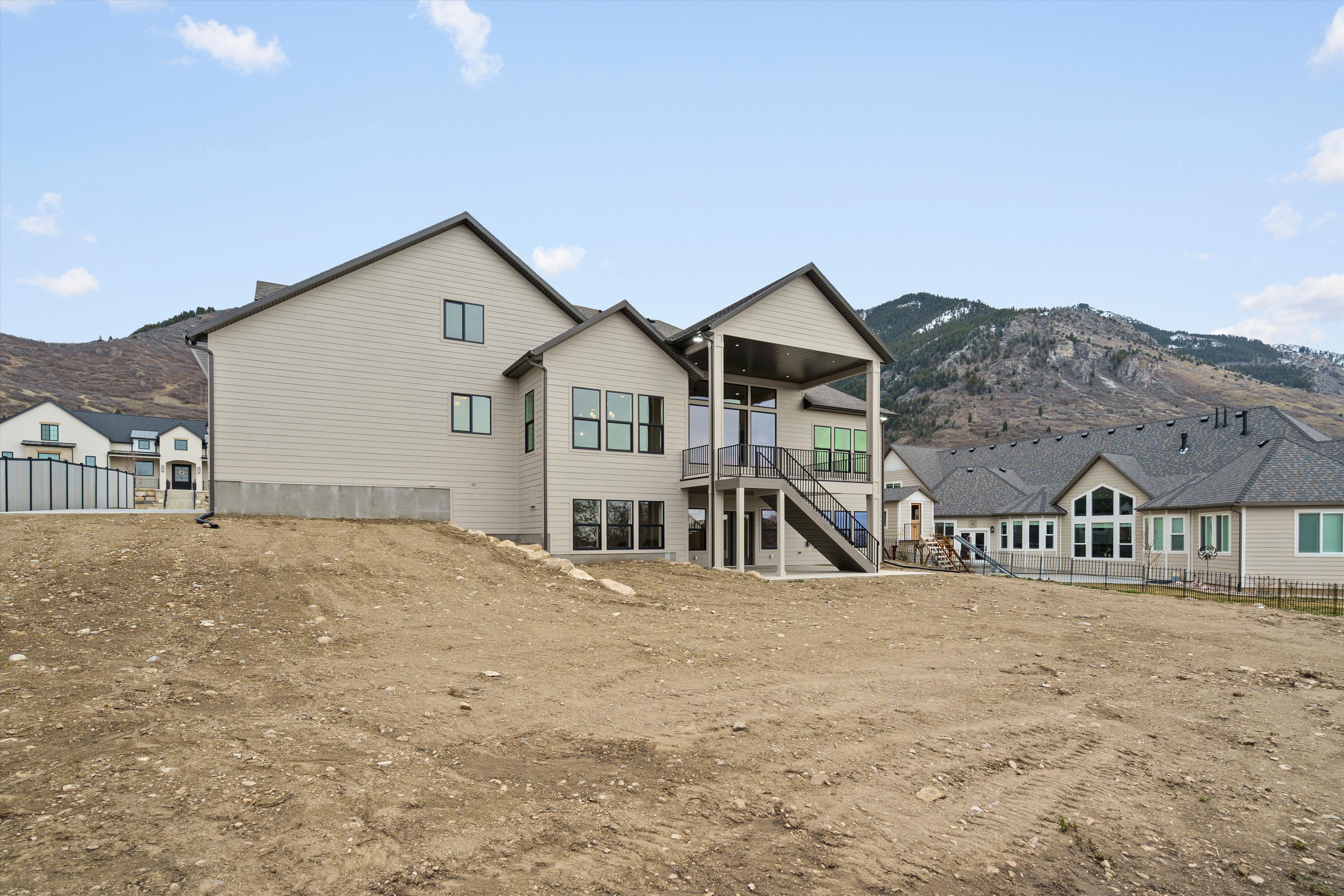 Rear view of house featuring a mountain view and a patio area