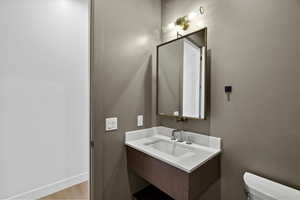 Half bath featuring vanity and toilet