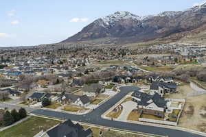 Aerial view of property's location with mountains and nearby suburban area