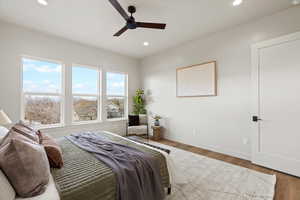Bedroom with wood finished floors, ceiling fan, and recessed lighting