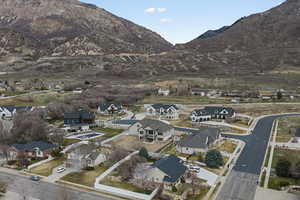 Aerial view of property's location with a mountain backdrop and nearby suburban area