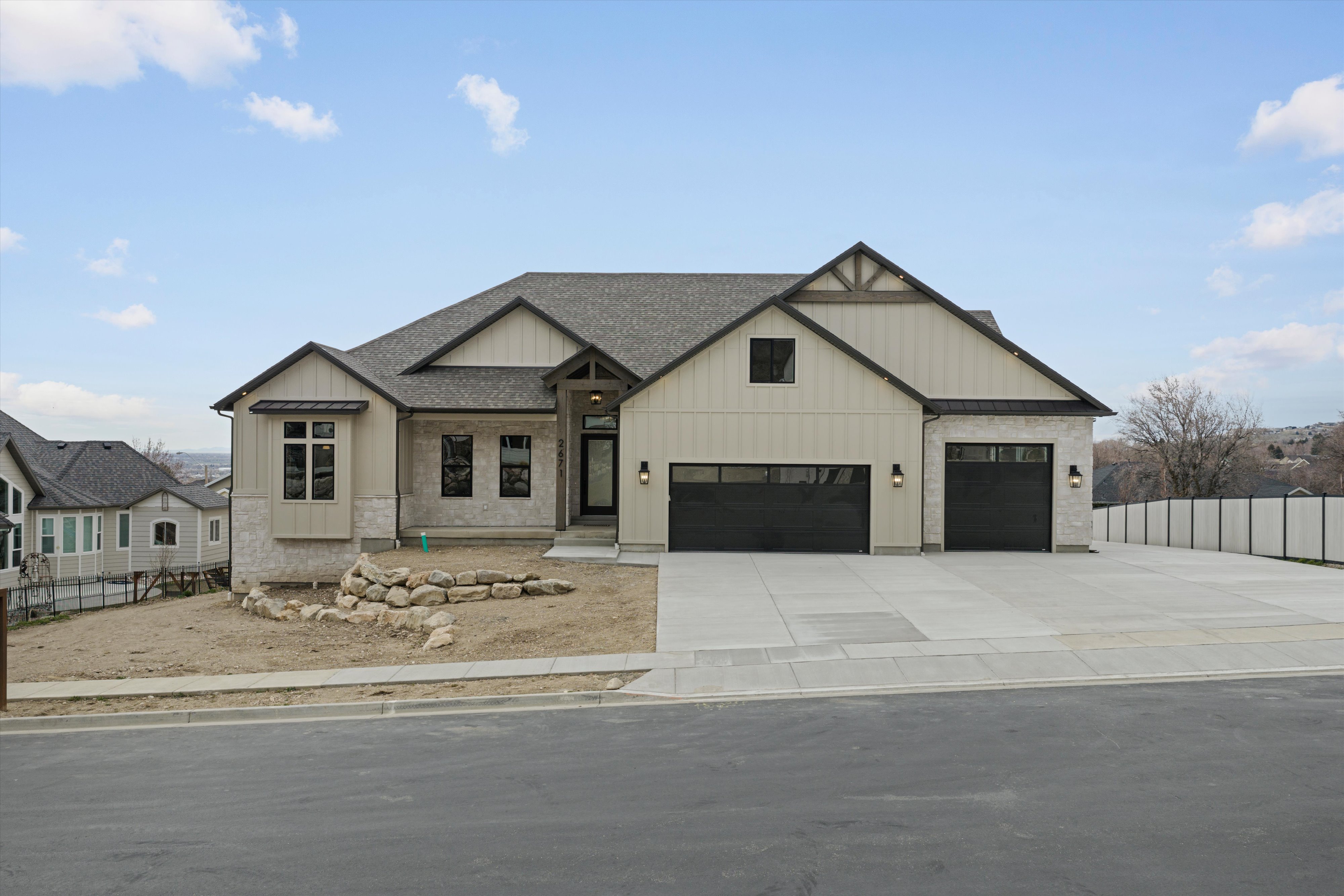 Modern farmhouse style home with board and batten siding, roof with shingles, concrete driveway, and an attached garage