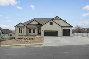 Modern farmhouse style home with board and batten siding, roof with shingles, concrete driveway, and an attached garage