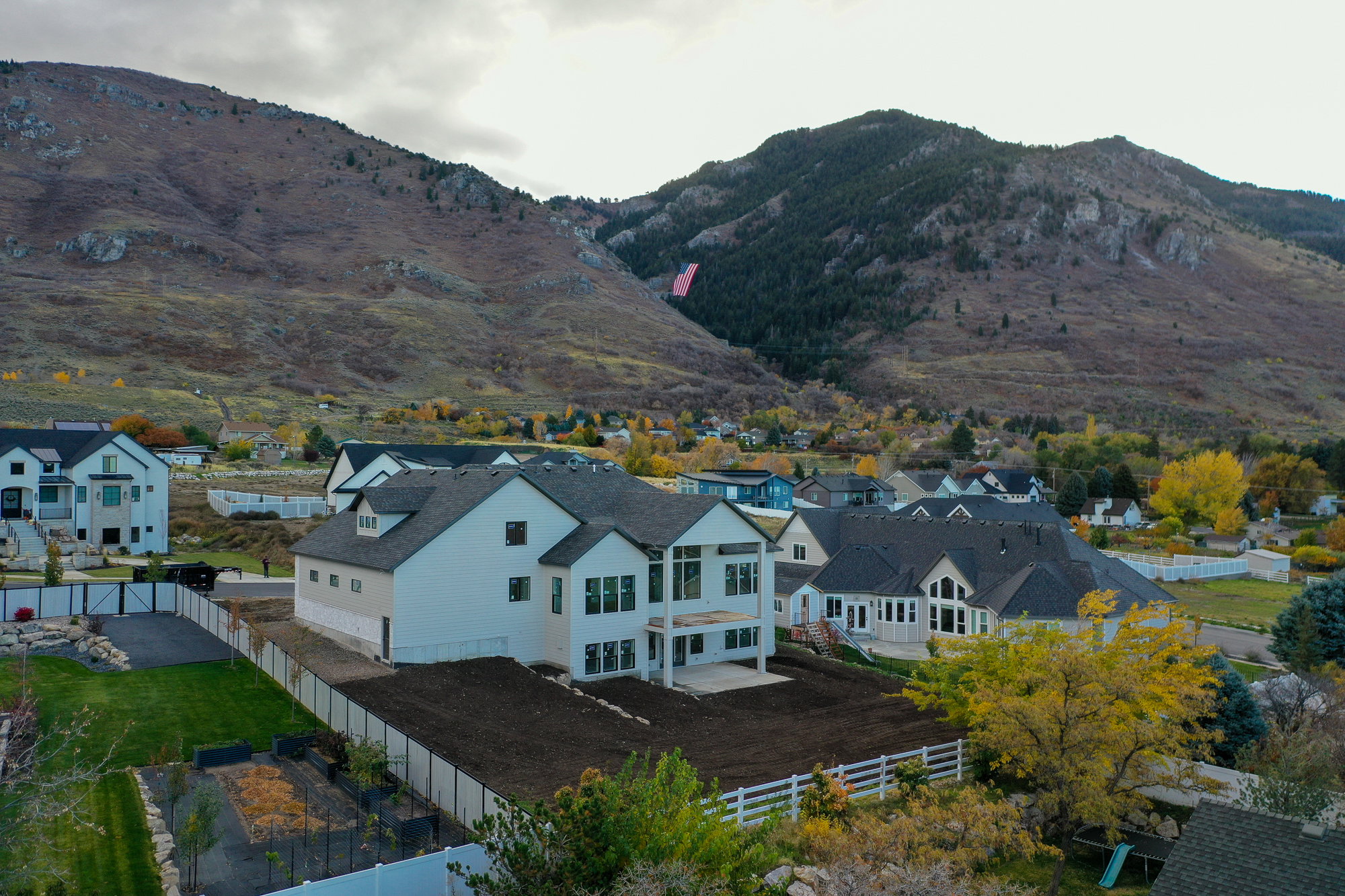 View of mountain backdrop featuring nearby suburban area
