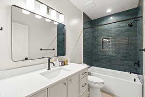 Full bathroom with vanity, bathtub / shower combination, and recessed lighting