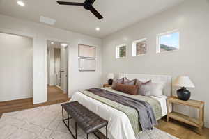 Bedroom featuring light wood-style flooring, a ceiling fan, and recessed lighting