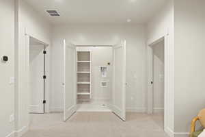 Unfurnished bedroom featuring light colored carpet