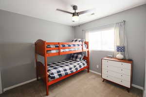 Bedroom featuring light colored carpet and a ceiling fan