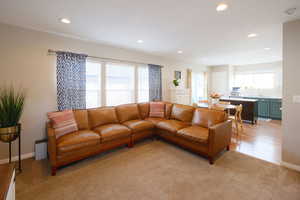 Living area featuring light carpet and recessed lighting
