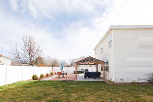 Fenced backyard featuring a patio, a gazebo, and an outdoor living space