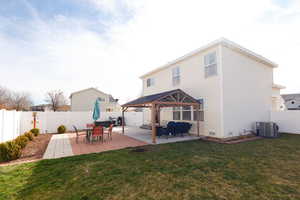 Back of house featuring a gazebo, a patio, a fenced backyard, and outdoor furniture