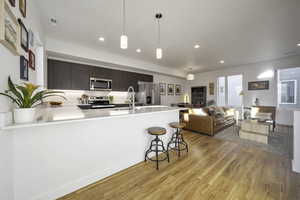 Well lit main floor is open with breakfast bar and modern kitchen.