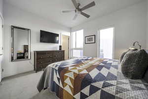 Bedroom featuring light carpet and a ceiling fan