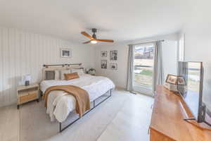 Spacious Owner’s Bedroom with light wood-style floors and a ceiling fan
