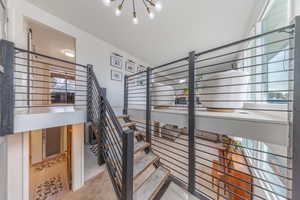 Metal Railing and Staircase with hanging lights and carpet runners