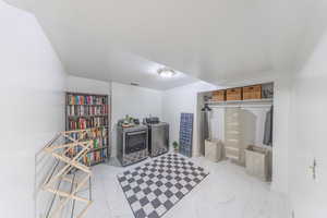 Laundry area featuring separate washer and dryer, baseboards, closet and extra storage/craft space.