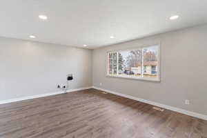 Spare room featuring wood finished floors and recessed lighting