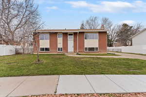 Bi-level home with brick siding and a chimney