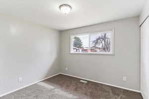 Empty room with baseboards and carpet