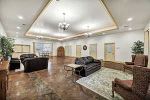Living room with a raised ceiling and hanging lights