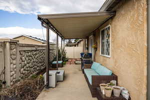 Fenced backyard featuring an outdoor living space and a patio