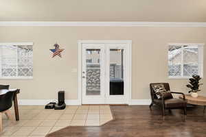 Interior space featuring ornamental molding and wood finished floors