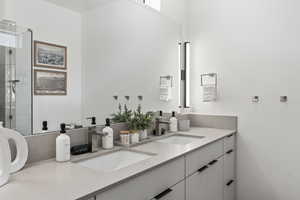 Bathroom with double vanity and a shower stall