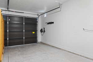 Garage featuring electric panel and car charger