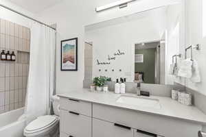 Ensuite bathroom featuring vanity and shower / bathtub combination with curtain