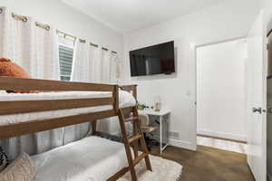 Bedroom with baseboards and an office area