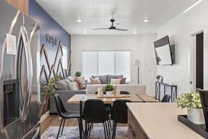 Dining space featuring light wood-style flooring, ceiling fan, and recessed lighting