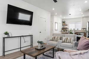 Living room featuring wood finished floors, recessed lighting, and ceiling fan