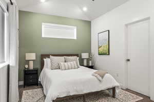 Bedroom featuring carpet floors and lofted ceiling