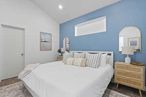 Bedroom featuring vaulted ceiling and carpet