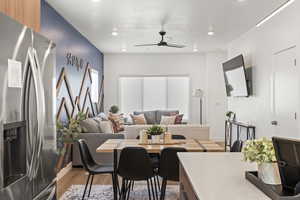 Dining room featuring light wood-style flooring, ceiling fan, and recessed lighting