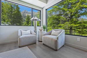 Living area with a mountain view and light wood-style floors