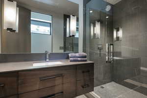 Bathroom with a stall shower and vanity