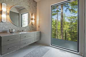 Bathroom with vanity and backsplash