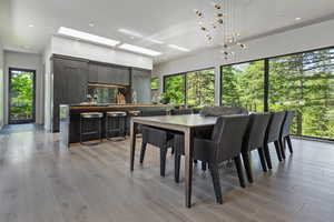 Dining room featuring a skylight, light wood-style floors, and recessed lighting