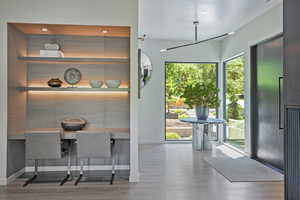Dining room featuring light wood-style flooring, an office area, and recessed lighting