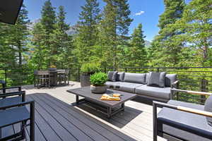 Deck with an outdoor living / dining area