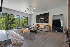Living area with wood-type flooring and hanging lights