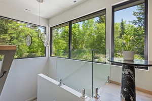 Unfurnished sunroom with view of scattered trees