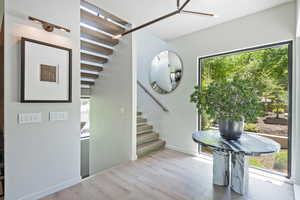 Foyer with stairway and light wood finished floors