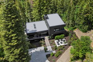 Aerial view of property and surrounding area featuring a heavily wooded area