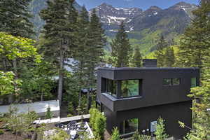View of side of home featuring a mountain view and a balcony