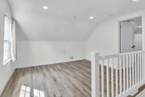 Bonus room featuring lofted ceiling, light wood-type flooring, and recessed lighting
