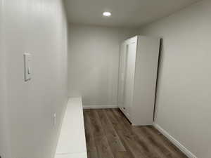 Hallway with dark wood-style floors and recessed lighting