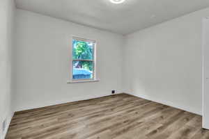 Unfurnished room with wood finished floors